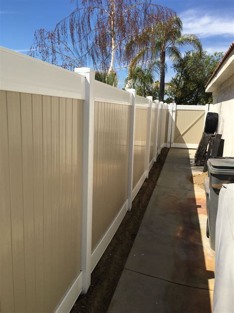 white and tan vinyl fence